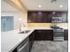 Updated kitchen with stainless steel appliances, dark cabinets, and a modern faucet at 18344 W Getty Dr, Goodyear, AZ 85338