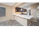 Modern kitchen with white countertops, stainless steel appliances, and dark wood cabinets at 18344 W Getty Dr, Goodyear, AZ 85338