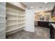 View of pantry featuring large shelves, tile floors, and plenty of room at 18344 W Getty Dr, Goodyear, AZ 85338