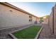 Fenced side yard with gravel and turf area at 18344 W Getty Dr, Goodyear, AZ 85338