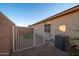 Side yard view with gravel, fence, and a small area of artificial turf at 18344 W Getty Dr, Goodyear, AZ 85338