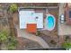 Aerial view of the home with a white roof, red tiled roof, long driveway and refreshing pool at 1917 E Karen Dr, Phoenix, AZ 85022