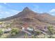Aerial view showing the home's proximity to a scenic desert mountain, pool and lush desert landscape at 1917 E Karen Dr, Phoenix, AZ 85022