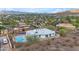 Aerial view showcasing the home, its pool, and lush landscaping within a desert community at 1917 E Karen Dr, Phoenix, AZ 85022