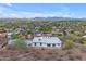 Aerial view of a white home with a pool, surrounded by desert landscape and city views at 1917 E Karen Dr, Phoenix, AZ 85022