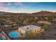 Breathtaking aerial view of home with private backyard pool, mountain views and city lights at 1917 E Karen Dr, Phoenix, AZ 85022