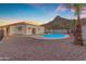 Backyard oasis featuring a private pool and mature palm trees against the backdrop of a desert landscape at 1917 E Karen Dr, Phoenix, AZ 85022