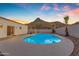 Sparkling pool surrounded by desert landscape featuring lounge chairs and palm trees at 1917 E Karen Dr, Phoenix, AZ 85022