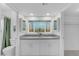 Bright bathroom with double sinks, grey countertops and large mirrors at 1917 E Karen Dr, Phoenix, AZ 85022