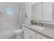 Beautifully renovated bathroom features a shower-over-tub and modern vanity with a marble countertop at 1917 E Karen Dr, Phoenix, AZ 85022