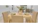 Close up of dining table set for four with green napkins and a plant in the center at 1917 E Karen Dr, Phoenix, AZ 85022