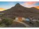 Single-story home with a red tile roof, a backyard pool, mountain views, and a desert landscape at 1917 E Karen Dr, Phoenix, AZ 85022