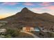 Inviting single-story home featuring a private pool and mountain views under a vibrant, colorful sky at 1917 E Karen Dr, Phoenix, AZ 85022