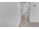 Hallway to bathroom features tile floors and crisp white walls at 1917 E Karen Dr, Phoenix, AZ 85022