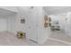 Bright hallway with light wood floors, white walls and mirrored wall that reflects the living room at 1917 E Karen Dr, Phoenix, AZ 85022