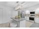 Bright kitchen features an island with seating, stainless steel appliances, and ample counter space at 1917 E Karen Dr, Phoenix, AZ 85022