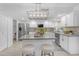 Bright kitchen featuring white cabinets, stainless steel appliances, an island, and stylish lighting at 1917 E Karen Dr, Phoenix, AZ 85022