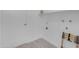 A functional laundry room with white walls and shelving and space for washer/dryer at 1917 E Karen Dr, Phoenix, AZ 85022