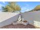 Cozy outdoor patio with stucco walls, white fireplace and gravel flooring with desert surroundings at 1917 E Karen Dr, Phoenix, AZ 85022