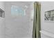Shower featuring marble tiling, showerhead and green shower curtain at 1917 E Karen Dr, Phoenix, AZ 85022