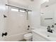 Bright bathroom featuring a shower-tub combination and sleek black fixtures at 2112 S 160Th Dr, Goodyear, AZ 85338