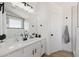 Modern bathroom with a white vanity, black hardware, and a window with views of the exterior at 2112 S 160Th Dr, Goodyear, AZ 85338