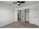 Bright bedroom features neutral carpet, ceiling fan, and ensuite bathroom access at 2112 S 160Th Dr, Goodyear, AZ 85338