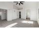 Well-lit bedroom with a ceiling fan, a walk-in closet, carpet, and access to the en-suite bathroom at 2112 S 160Th Dr, Goodyear, AZ 85338