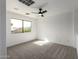 Bedroom featuring a large window with an exterior view and neutral carpet at 2112 S 160Th Dr, Goodyear, AZ 85338