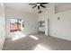 Carpeted bedroom featuring a ceiling fan and access to an en-suite bathroom for added convenience at 2112 S 160Th Dr, Goodyear, AZ 85338