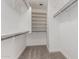 Walk-in closet equipped with ample shelving and metal bars for efficient storage and organization at 2112 S 160Th Dr, Goodyear, AZ 85338