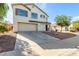 Two story home with a two-car garage and desert landscaping provides attractive curb appeal at 2112 S 160Th Dr, Goodyear, AZ 85338