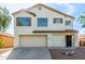 Charming two-story home featuring a red tile roof, neutral stucco exterior, and attached two-car garage at 2112 S 160Th Dr, Goodyear, AZ 85338