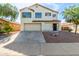 Inviting two-story home with a well-maintained front yard and a two car garage at 2112 S 160Th Dr, Goodyear, AZ 85338