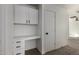 Hallway with built-in desk, cabinets, drawers, and neutral carpet at 2112 S 160Th Dr, Goodyear, AZ 85338