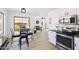 Open kitchen and living area with granite countertops, breakfast table, and stainless steel appliances at 2112 S 160Th Dr, Goodyear, AZ 85338