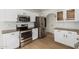 Contemporary kitchen features granite countertops, stainless steel appliances, and white cabinetry at 2112 S 160Th Dr, Goodyear, AZ 85338