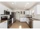 Modern kitchen with stainless steel appliances, granite countertops, and white cabinetry at 2112 S 160Th Dr, Goodyear, AZ 85338