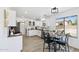 Modern kitchen with white cabinets, granite countertops, and a cozy breakfast nook at 2112 S 160Th Dr, Goodyear, AZ 85338