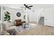 Bright living room with a stylish brown sofa, modern decor, and contemporary ceiling fan at 2112 S 160Th Dr, Goodyear, AZ 85338