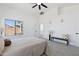 Bright bedroom featuring access to ensuite, ceiling fan, and neutral colored carpet and furnishings at 2112 S 160Th Dr, Goodyear, AZ 85338
