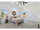 Bright main bedroom featuring large windows, a ceiling fan, and neutral decor and furnishings at 2112 S 160Th Dr, Goodyear, AZ 85338