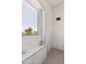Modern shower featuring white marble-style tile, black trim, and a window overlooking the exterior at 2112 S 160Th Dr, Goodyear, AZ 85338
