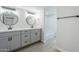 Modern bathroom with dual vanity, sleek fixtures, and a separate shower at 2223 E Catalina Dr, Phoenix, AZ 85016