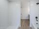 Bright bathroom featuring a tiled shower and modern wood-look flooring at 2223 E Catalina Dr, Phoenix, AZ 85016