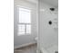 Bathroom features a shower with updated fixtures and natural light from a window at 2223 E Catalina Dr, Phoenix, AZ 85016