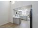 Bright eat-in kitchen features stainless appliances, gray cabinets, skylight and an island, enhancing modern appeal at 2223 E Catalina Dr, Phoenix, AZ 85016