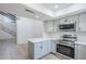 This light and bright eat-in kitchen has gray cabinets, stainless appliances, and a large island at 2223 E Catalina Dr, Phoenix, AZ 85016