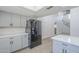 This open kitchen has gray cabinets, stainless appliances, and a large island at 2223 E Catalina Dr, Phoenix, AZ 85016