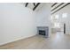 A bright living room features vaulted ceilings and a unique tiled fireplace with modern flooring at 2223 E Catalina Dr, Phoenix, AZ 85016